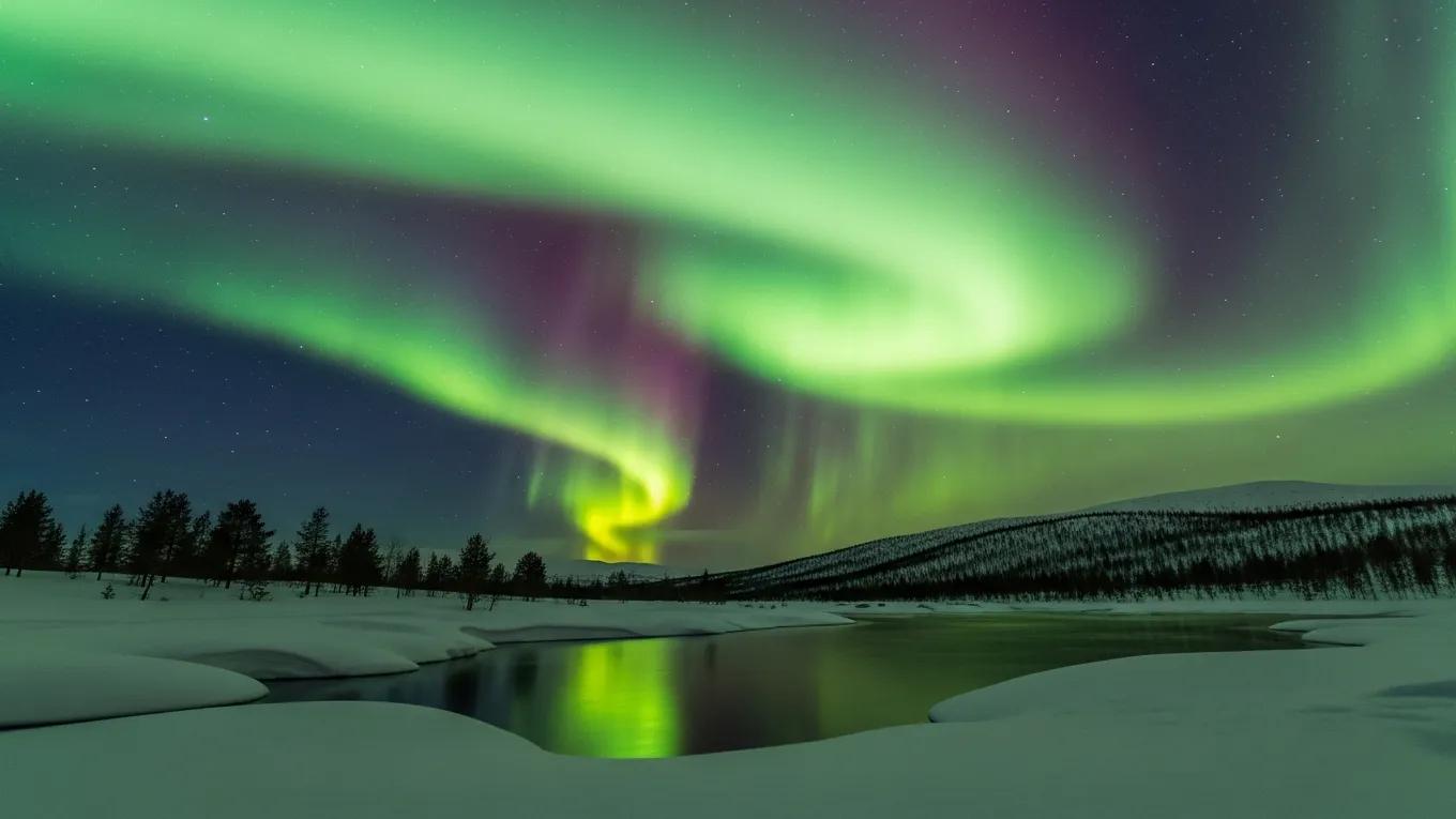 Vibrant Northern Lights over a snowy Norwegian landscape